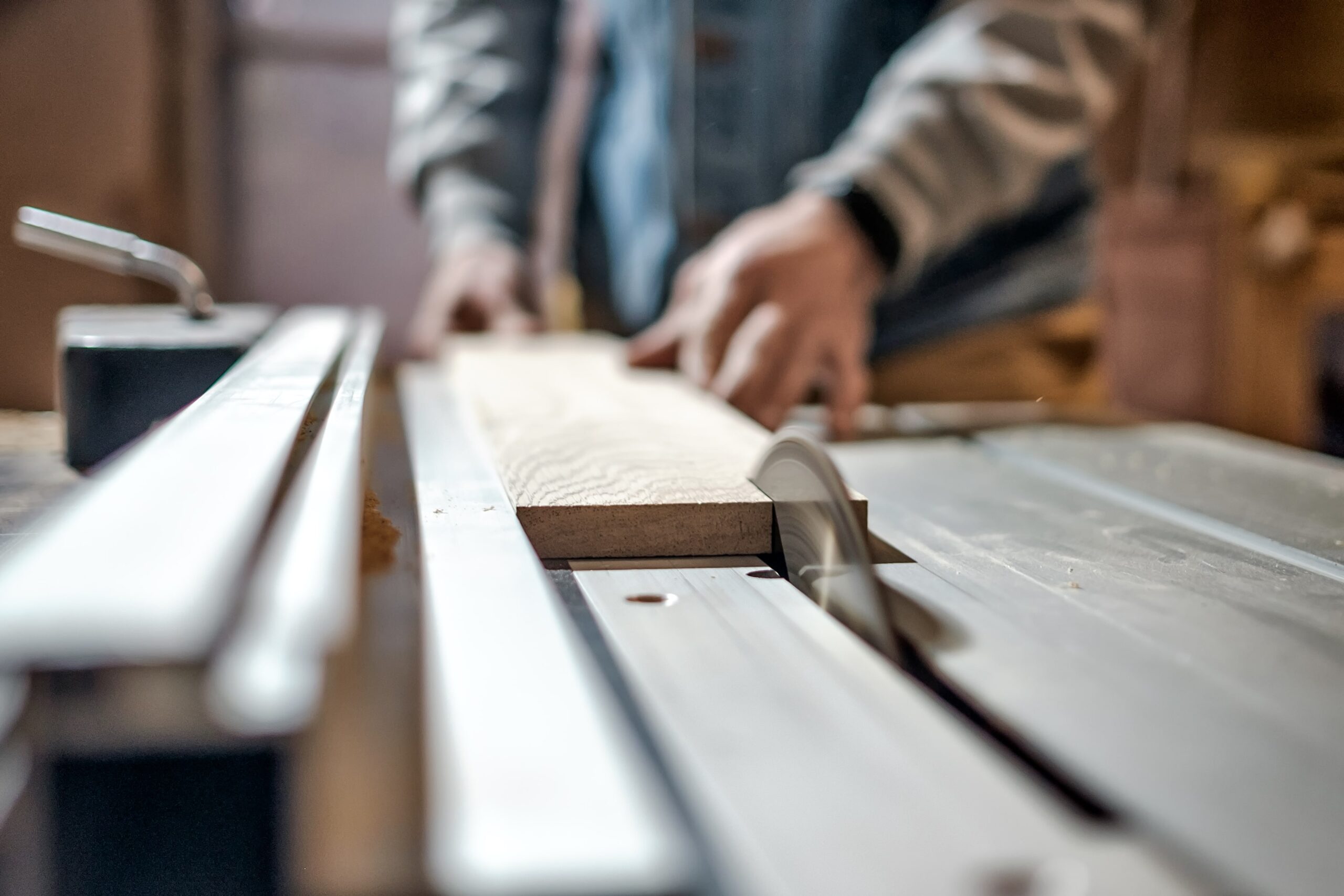 A man cutting wood, emphasizing the importance of a dust collector.