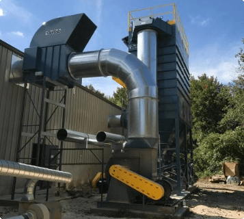 A Belfab dust collector installed outside of an industrial building.
